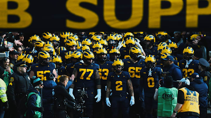 The Michigan Wolverines enter Michigan Stadium