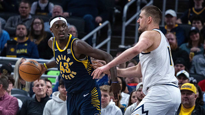 Feb 24, 2025; Indianapolis, Indiana, USA; Indiana Pacers forward Pascal Siakam (43) dribbles the ball while Denver Nuggets center Nikola Jokic (15) defends in the second half at Gainbridge Fieldhouse. Mandatory Credit: Trevor Ruszkowski-Imagn Images
