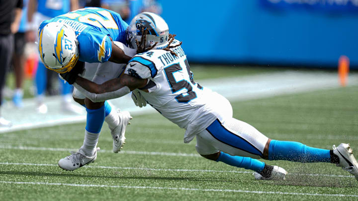 Sep 15, 2024; Charlotte, North Carolina, USA; Los Angeles Chargers running back J.K. Dobbins (27) is tackled by Carolina Panthers linebacker Shaq Thompson (54) during the second half at Bank of America Stadium. Mandatory Credit: Jim Dedmon-Imagn Images Sep 15, 2024; Charlotte, North Carolina, USA; Los Angeles Chargers running back J.K. Dobbins (27) is tackled by Carolina Panthers linebacker Shaq Thompson (54) during the second half at Bank of America Stadium. Mandatory Credit: Jim Dedmon-Imagn Images
