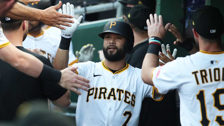 Jun 4, 2025; Pittsburgh, Pennsylvania, USA;  Pittsburgh Pirates shortstop Isiah Kiner-Falefa (7) high-fives in the dugout after driving in a run with a sacrifice fly against the Houston Astros during the second inning at PNC Park. Mandatory Credit: Charles LeClaire-Imagn Images