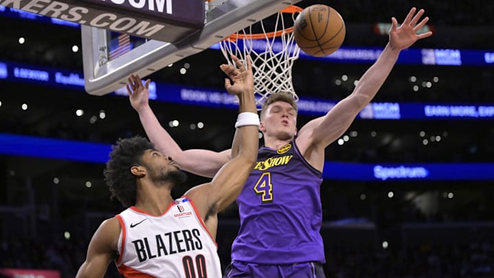 Jan 2, 2025; Los Angeles, California, USA; Los Angeles Lakers guard Dalton Knecht (4) defends a shot by Portland Trail Blazers guard Scoot Henderson (00) in the first half at Crypto.com Arena. Mandatory Credit: Jayne Kamin-Oncea-Imagn Images Jan 2, 2025; Los Angeles, California, USA; Los Angeles Lakers guard Dalton Knecht (4) defends a shot by Portland Trail Blazers guard Scoot Henderson (00) in the first half at Crypto.com Arena. Mandatory Credit: Jayne Kamin-Oncea-Imagn Images
