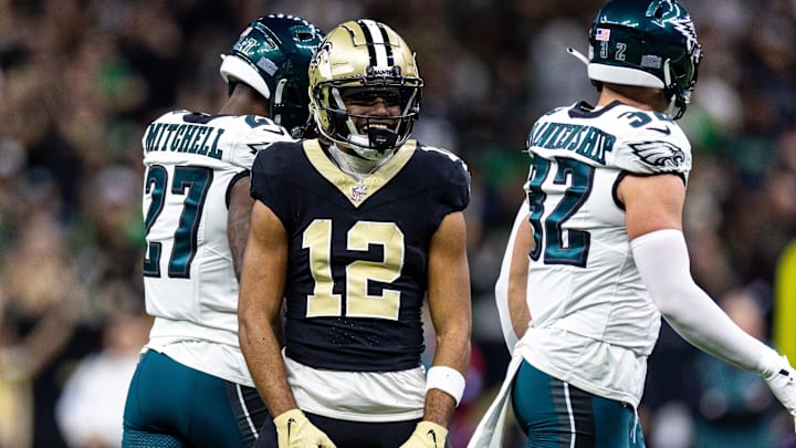 Sep 22, 2024; New Orleans, Louisiana, USA; New Orleans Saints wide receiver Chris Olave (12) reacts to making a first down reception against Philadelphia Eagles safety Reed Blankenship (32) during the first half at Caesars Superdome. Mandatory Credit: Stephen Lew-Imagn Images