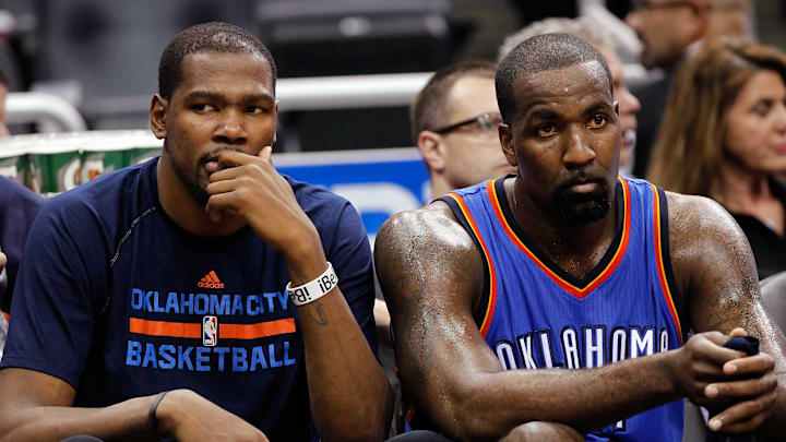 Oklahoma City Thunder forward Kevin Durant and center Kendrick Perkins look on from the bench in a 2015 game against the Orlando Magic.