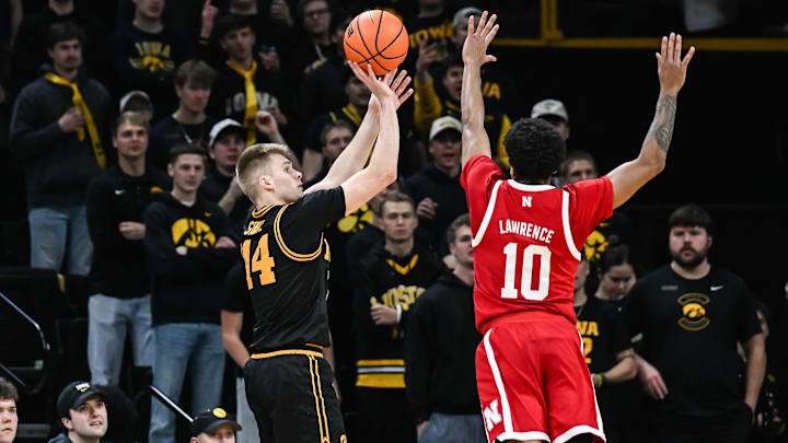 Feb 17, 2026; Iowa City, Iowa, USA; Iowa Hawkeyes guard Bennett Stirtz (14) shoots the ball over Nebraska Cornhuskers guard Jamarques Lawrence (10) during the first half at Carver-Hawkeye Arena. Mandatory Credit: Jeffrey Becker-Imagn Images Feb 17, 2026; Iowa City, Iowa, USA; Iowa Hawkeyes guard Bennett Stirtz (14) shoots the ball over Nebraska Cornhuskers guard Jamarques Lawrence (10) during the first half at Carver-Hawkeye Arena. Mandatory Credit: Jeffrey Becker-Imagn Images