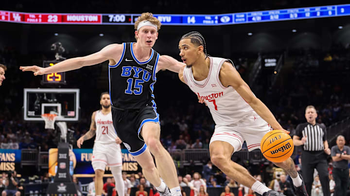 Mar 14, 2025; Kansas City, MO, USA; Houston Cougars guard Milos Uzan (7) drives to the basket around Brigham Young Cougars forward Richie Saunders (15) during the first half at T-Mobile Center. Mandatory Credit: William Purnell-Imagn Images