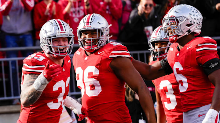Ohio State Buckeyes defensive end Jack Sawyer, left, celebrates with teammates.