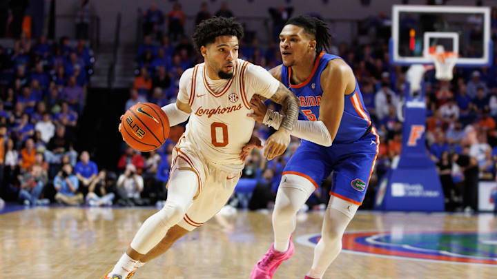 Jan 18, 2025; Gainesville, Florida, USA; Texas Longhorns guard Jordan Pope (0) drives to the basket past Florida Gators guard Will Richard (5) during the first half at Exactech Arena at the Stephen C. O'Connell Center. Mandatory Credit: Matt Pendleton-Imagn Images Jan 18, 2025; Gainesville, Florida, USA; Texas Longhorns guard Jordan Pope (0) drives to the basket past Florida Gators guard Will Richard (5) during the first half at Exactech Arena at the Stephen C. O'Connell Center. Mandatory Credit: Matt Pendleton-Imagn Images