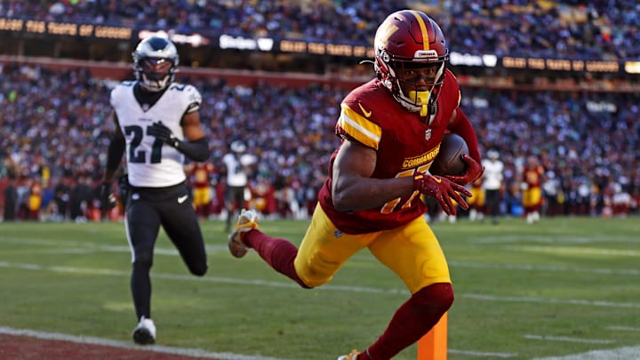 Dec 22, 2024; Landover, Maryland, USA; Washington Commanders wide receiver Terry McLaurin (17) catches a touchdown  pass against Philadelphia Eagles cornerback Quinyon Mitchell (27) during the second quarter at Northwest Stadium. Mandatory Credit: Peter Casey-Imagn Images