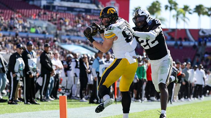 Dec 31, 2025; Tampa, FL, USA; Iowa Hawkeyes tight end DJ Vonnahme (81) receives a pass for a touchdown defended by Vanderbilt Commodores linebacker Bryce Cowan (22) in the third quarter during the ReliaQuest Bowl at Raymond James Stadium. Mandatory Credit: Nathan Ray Seebeck-Imagn Images