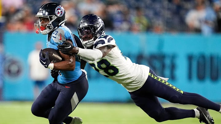 Tennessee Titans wide receiver Jha'Quan Jackson (19) is hit by Seattle Seahawks cornerback Nehemiah Pritchett (28) during the fourth quarter at Nissan Stadium in Nashville, Tenn., Saturday, Aug. 17, 2024.