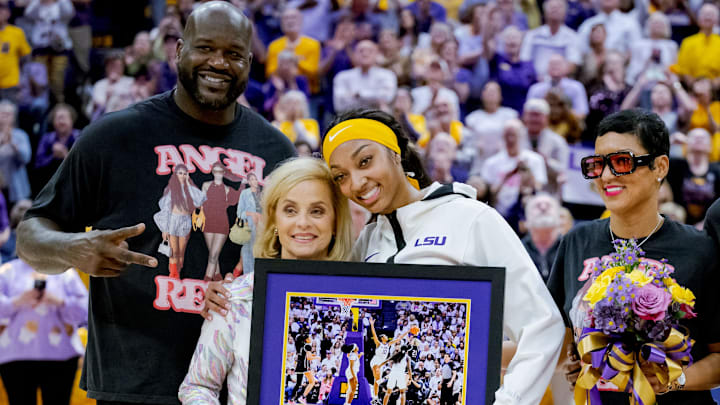Mar 3, 2024; Baton Rouge, Louisiana, USA; LSU Lady Tigers forward Angel Reese takes a photo for senior night with former LSU player and NBA champion Shaquille O'Neal, LSU Lady Tigers head coach Kim Mulkey, and Reese’s mother Angel Webb against the Kentucky Wildcats at Pete Maravich Assembly Center. Mandatory Credit: Matthew Hinton-Imagn Images