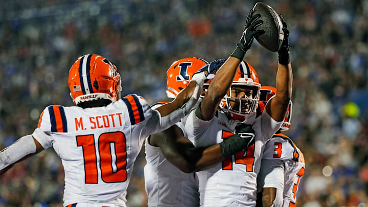 Sep 8, 2023; Lawrence, Kansas, USA; Illinois Fighting Illini defensive back Xavier Scott (14) celebrates with teammates after an interception during the second half against the Kansas Jayhawks at David Booth Kansas Memorial Stadium. Mandatory Credit: Jay Biggerstaff-USA TODAY Sports