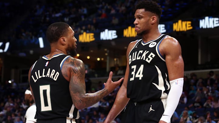 Milwaukee Bucks guard Damian Lillard (0) talks with forward Giannis Antetokounmpo (34) during a time out at FedExForum.