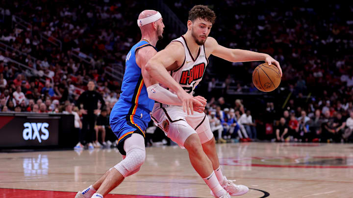 Apr 4, 2025; Houston, Texas, USA; Houston Rockets center Alperen Sengun (28) handles the ball against Oklahoma City Thunder guard Alex Caruso (9) during the second quarter at Toyota Center. Mandatory Credit: Erik Williams-Imagn Images
