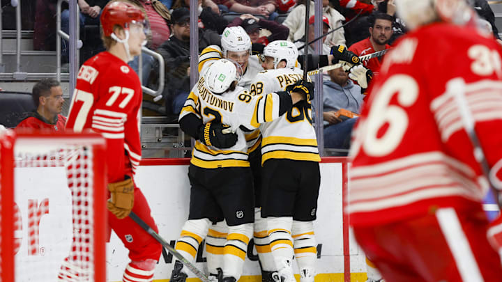 Mar 21, 2026; Detroit, Michigan, USA; Boston Bruins defenseman Nikita Zadorov (91) celebrates with right wing David Pastrnak (88) and center Marat Khusnutdinov (92) after scoring a goal in the third period against the Detroit Red Wings at Little Caesars Arena. Mandatory Credit: Brian Bradshaw Sevald-Imagn Images