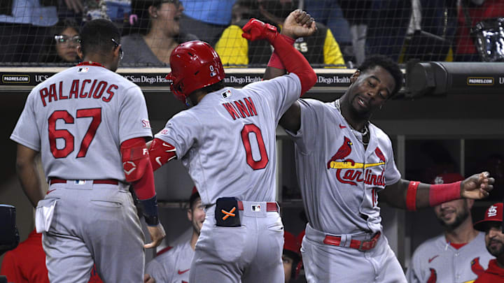 Sep 22, 2023; San Diego, California, USA; St. Louis Cardinals shortstop Masyn Winn (0) is congratulated at the dugout by right fielder Jordan Walker (18) after hitting a home run against the San Diego Padres during the sixth inning at Petco Park. Mandatory Credit: Orlando Ramirez-Imagn Images