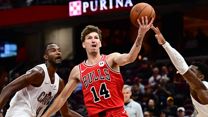 Oct 7, 2025; Cleveland, Ohio, USA; Chicago Bulls forward Matas Buzelis (14) drives to the basket between Cleveland Cavaliers forward Evan Mobley (4) and guard Donovan Mitchell (45) during the second half at Rocket Arena. Mandatory Credit: Ken Blaze-Imagn Images