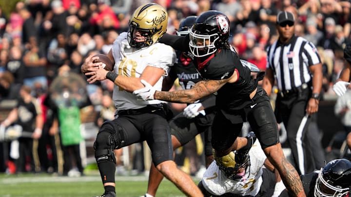 UCF's quarterback John Rhys Plumlee (10) gets taken down by UC's defense during the UC vs. UCF game at Nippert Stadium on Saturday, November 4, 2023. UCF leads the game at halftime with a score of 14-10.