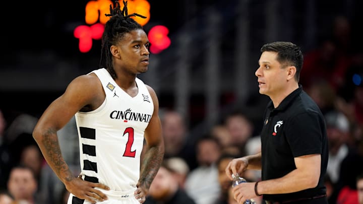 Cincinnati Bearcats head coach Wes Miller, right, talks with Cincinnati Bearcats guard Jizzle James (2) in the first half of a college basketball game against the Bradley Braves during a second-round game of the National Invitation Tournament,, Saturday, March 23, 2024, at Fifth Third Arena in Cincinnati. Cincinnati Bearcats head coach Wes Miller, right, talks with Cincinnati Bearcats guard Jizzle James (2) in the first half of a college basketball game against the Bradley Braves during a second-round game of the National Invitation Tournament,, Saturday, March 23, 2024, at Fifth Third Arena in Cincinnati.