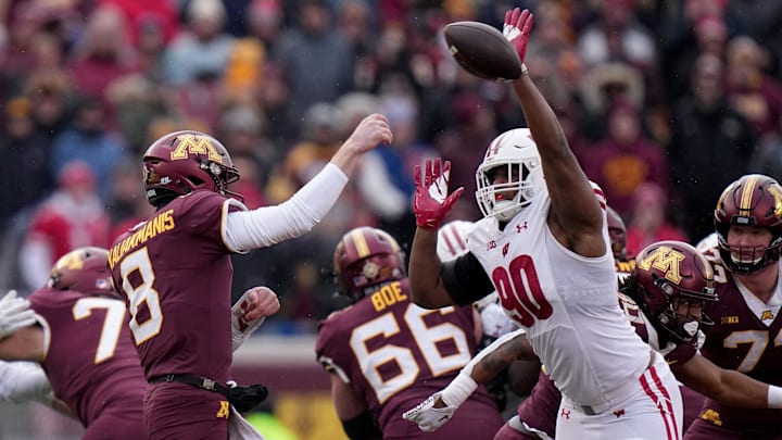 Wisconsin defensive end James Thompson Jr. (90) bats away a pass by Minnesota quarterback Athan Kaliakmanis (8) during the first quarter of their game Saturday, November 25, 2023 at Huntington Bank Stadium in Minneapolis, Minnesota. Wisconsin beat Minnesota 28-14.