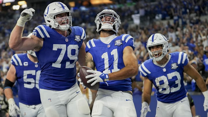 Sep 10, 2023; Indianapolis, Indiana, USA; Indianapolis Colts offensive tackle Bernhard Raimann (79) and Indianapolis Colts tight end Kylen Granson (83) celebrate with Indianapolis Colts wide receiver Michael Pittman Jr. (11) after a touchdown at Lucas Oil Stadium. Mandatory Credit: Jenna Watson-Imagn Images