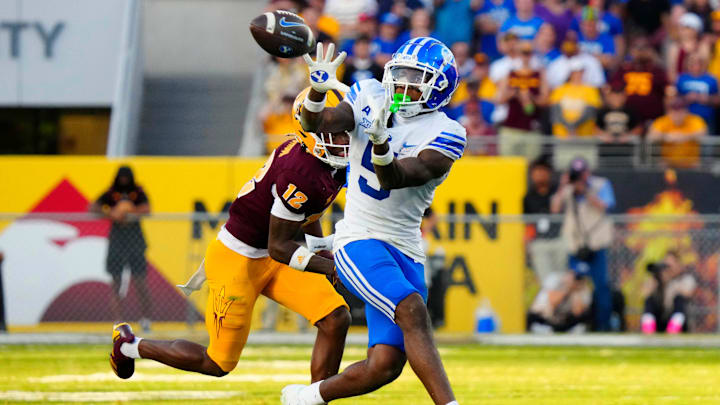 BYU wide receiver Darius Lassiter (5) makes a catch against Arizona State defensive back Javan Robinson (12) during the second half at Mountain America Stadium in Tempe on Nov. 23, 2024. BYU wide receiver Darius Lassiter (5) makes a catch against Arizona State defensive back Javan Robinson (12) during the second half at Mountain America Stadium in Tempe on Nov. 23, 2024.