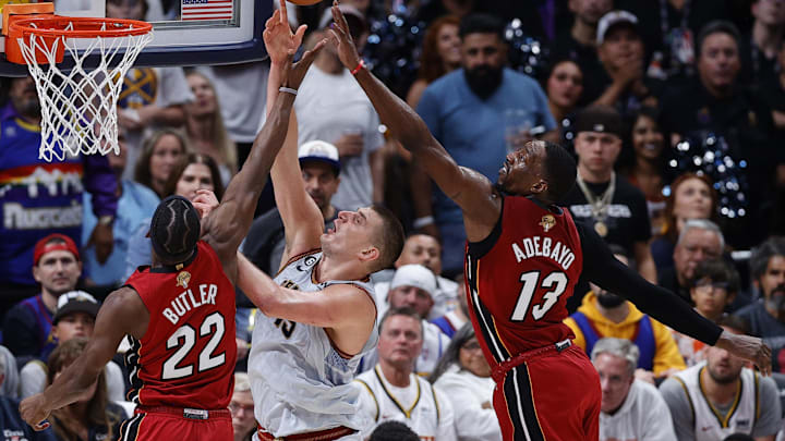Jun 12, 2023; Denver, Colorado, USA; Denver Nuggets center Nikola Jokic (15) battles for a rebound against Miami Heat forward Jimmy Butler (22) and center Bam Adebayo (13) during the third quarter of game five of the 2023 NBA Finals at Ball Arena. Mandatory Credit: Isaiah J. Downing-Imagn Images