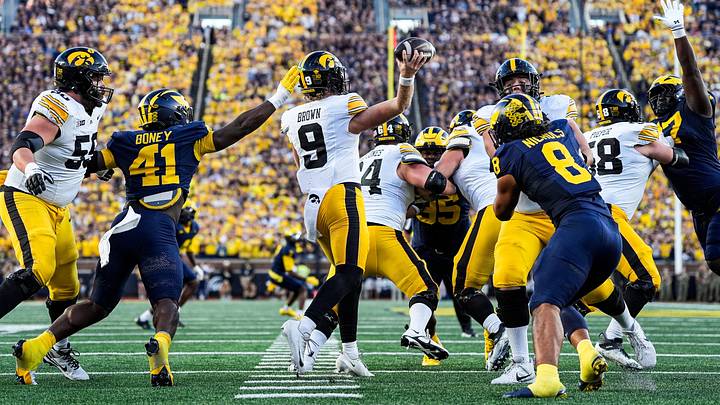 Iowa quarterback Hank Brown (9) makes a pass against Michigan defensive end Tariq Boney (41) during the second half at Michigan Stadium in Ann Arbor on Saturday, Sept. 26, 2026.