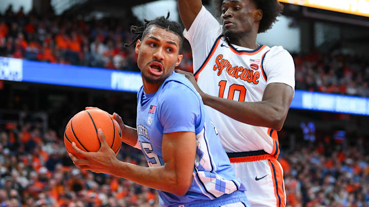 Feb 21, 2026; Syracuse, New York, USA; North Carolina Tar Heels forward Jarin Stevenson (15) drives against Syracuse Orange forward Ibrahim Souare (10) during the first half at the JMA Wireless Dome. Mandatory Credit: Rich Barnes-Imagn Images
