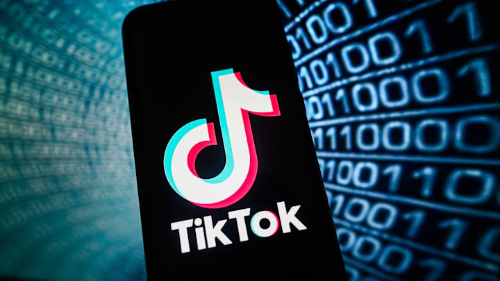 In this photo illustration a TikTok logo is displayed on a...
