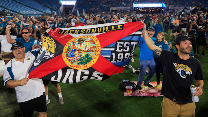 Marco Mere, left, and Christiano Verderese wave a custom Jaguars/Florida flag during the Duuval Draft Party Thursday, April 25, 2024 at EverBank Stadium in Jacksonville, Fla. Thousands came out to watch the Jacksonville Jaguars choose in the 2024 NFL Draft. With the 23rd overall pick, the Jacksonville Jaguars selected LSU’s wide receiver Brian Thomas Jr. “I love it, wide receiver baby!” Mere said. “Strong offense, that’s great.” [Corey Perrine/Florida Times-Union]