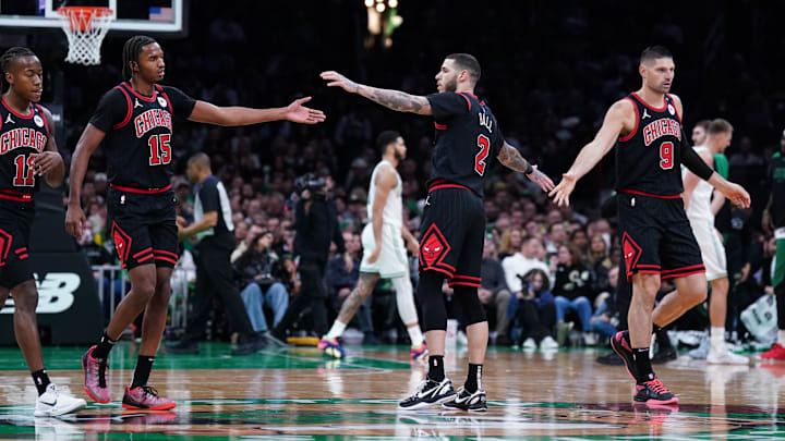 Dec 19, 2024; Boston, Massachusetts, USA; Chicago Bulls guard Lonzo Ball (2), center Nikola Vucevic (9) and forward Julian Phillips (15) react during a break in the action against the Boston Celtics in the second quarter at TD Garden. Mandatory Credit: David Butler II-Imagn Images
