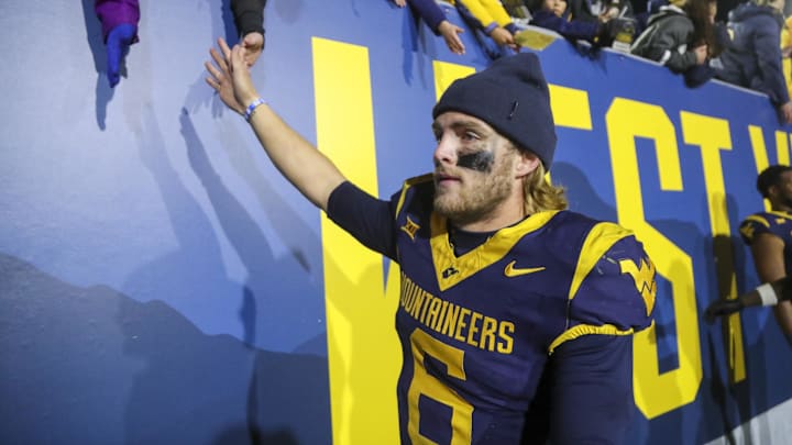 Nov 23, 2024; Morgantown, West Virginia, USA; West Virginia Mountaineers quarterback Garrett Greene (6) celebrates with fans after defeating the UCF Knights at Mountaineer Field at Milan Puskar Stadium. Mandatory Credit: Ben Queen-Imagn Images Nov 23, 2024; Morgantown, West Virginia, USA; West Virginia Mountaineers quarterback Garrett Greene (6) celebrates with fans after defeating the UCF Knights at Mountaineer Field at Milan Puskar Stadium. Mandatory Credit: Ben Queen-Imagn Images