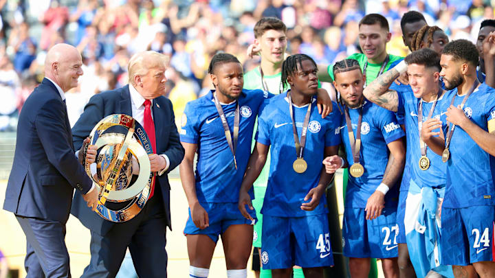 Gianni Infantino and Donald Trump hand over the Club World Cup trophy to Chelsea.