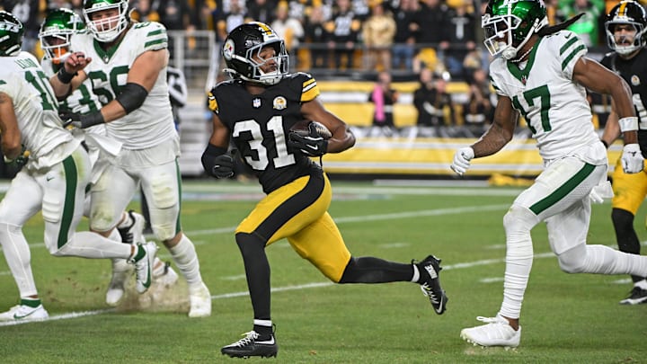 Oct 20, 2024; Pittsburgh, Pennsylvania, USA; Pittsburgh Steelers cornerback Beanie Bishop Jr. (31) returns an interception while being chased by New York Jets wide receiver Davante Adams (17) during the third quarter at Acrisure Stadium. Mandatory Credit: Barry Reeger-Imagn Images