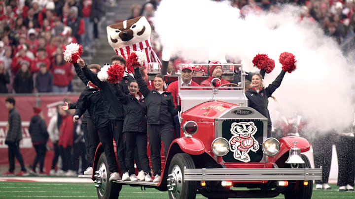 Bucky Badger rides the Bucky Wagon before the start of the Wisconsin - Washington football game Saturday, November 8, 2025 at Camp Randall Stadium in Madison, Wisconsin. The truck 1932 American LaFrance fire engine that was fitted with an electric motor in 2011 by engineering students.