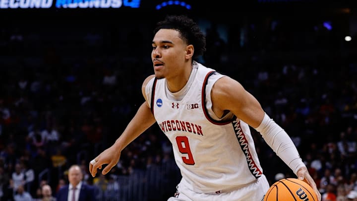 Mar 20, 2025; Denver, CO, USA; Wisconsin Badgers guard John Tonje (9) dribbles the ball against the Montana Grizzlies during the first half in the first round of the NCAA Tournament at Ball Arena. Mandatory Credit: Isaiah J. Downing-Imagn Images