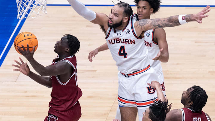South Carolina Gamecocks guard Morris Ugusuk (15) reverses his shot while guarded by Auburn Tigers forward Johni Broome (4) during their SEC Men's Basketball Tournament quarterfinal game at Bridgestone Arena in Nashville, Tenn., Friday, March 15, 2024.at Bridgestone Arena in Nashville, Tenn., Friday, March 15, 2024.