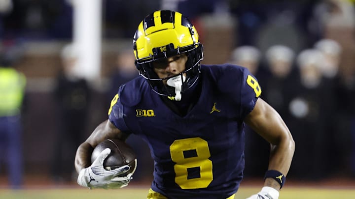 Nov 23, 2024; Ann Arbor, Michigan, USA;  Michigan Wolverines wide receiver Tyler Morris (8) runs the ball against the Northwestern Wildcats in the second half at Michigan Stadium. Mandatory Credit: Rick Osentoski-Imagn Images