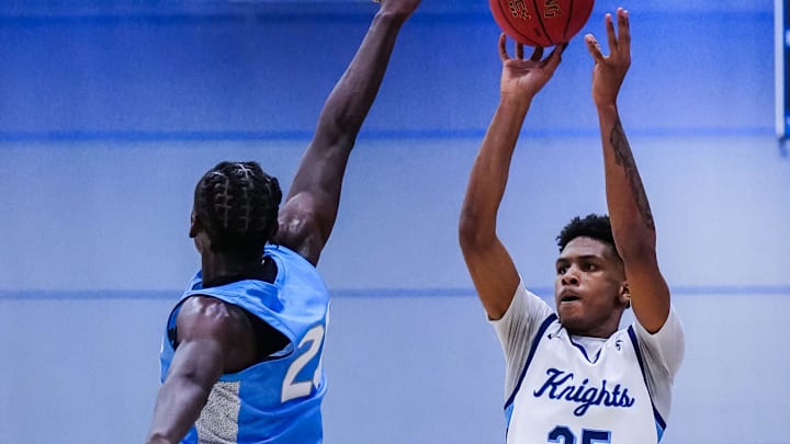 Nicolet's Davion Hannah (25) shoots over St. Thomas More's Sekou Konneh during the Rick Majerus Wisconsin Basketball Yearbook Shootout at Concordia University in Mequon on Friday, Dec. 29, 2023. Nicolet's Davion Hannah (25) shoots over St. Thomas More's Sekou Konneh during the Rick Majerus Wisconsin Basketball Yearbook Shootout at Concordia University in Mequon on Friday, Dec. 29, 2023.