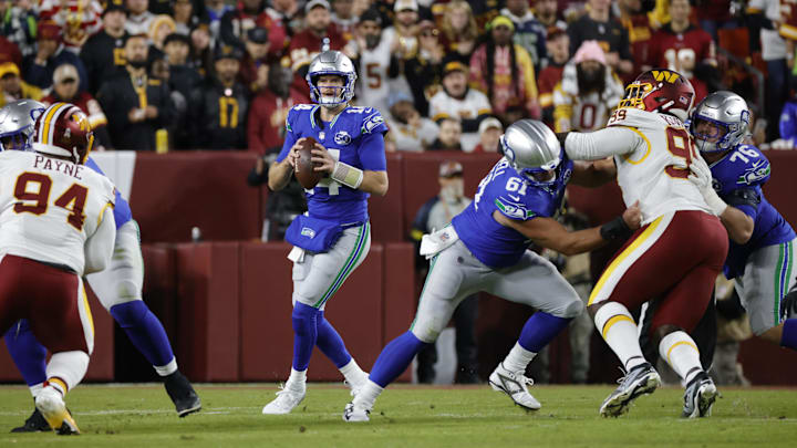 Nov 2, 2025; Landover, Maryland, USA; Seattle Seahawks quarterback Sam Darnold (14) looks to pass during the first half against the Washington Commanders during the first half at Northwest Stadium. Mandatory Credit: Amber Searls-Imagn Images
