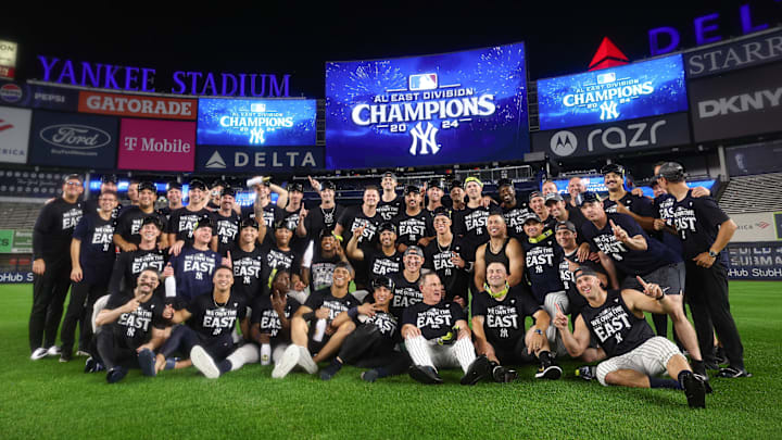 Sep 26, 2024; Bronx, New York, USA; New York Yankees pose for a photo in front of the main scoreboard after defeating the Baltimore Orioles to clinch the American League East division title at Yankee Stadium. Mandatory Credit: Vincent Carchietta-Imagn Images