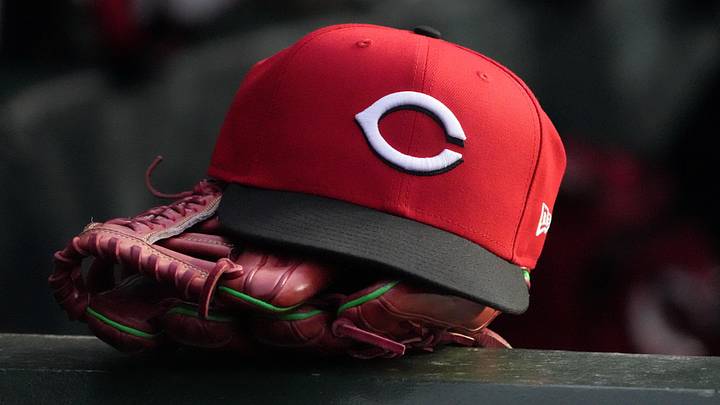 A detail shot of Cincinnati Reds hat and glove in the dugout A detail shot of Cincinnati Reds hat and glove in the dugout