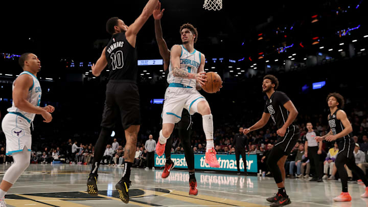 Nov 19, 2024; Brooklyn, New York, USA; Charlotte Hornets guard LaMelo Ball (1) looks to pass the ball against Brooklyn Nets guard Ben Simmons (10) and forwards Dorian Finney-Smith (28) and Cameron Johnson (2) during the first quarter at Barclays Center. Mandatory Credit: Brad Penner-Imagn Images