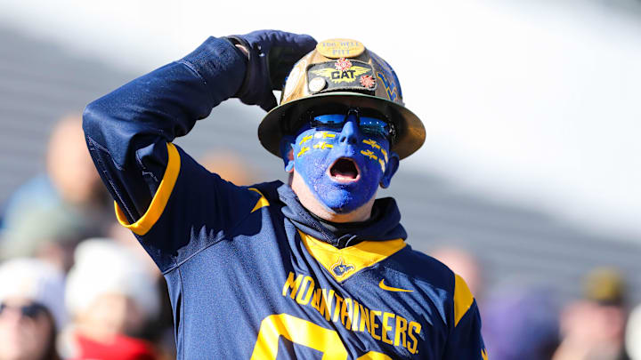 Nov 29, 2025; Morgantown, West Virginia, USA; A West Virginia Mountaineers fan yells during the first quarter against the Texas Tech Red Raiders at Milan Puskar Stadium. Mandatory Credit: Ben Queen-Imagn Images Nov 29, 2025; Morgantown, West Virginia, USA; A West Virginia Mountaineers fan yells during the first quarter against the Texas Tech Red Raiders at Milan Puskar Stadium. Mandatory Credit: Ben Queen-Imagn Images