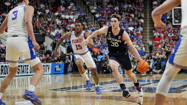 Mar 23, 2025; Raleigh, NC, USA; Connecticut Huskies forward Liam McNeeley (30) drives to the basket as Florida Gators guard Alijah Martin (15) defends during the second half in the second round of the NCAA Tournament at Lenovo Center. Mandatory Credit: Bob Donnan-Imagn Images Mar 23, 2025; Raleigh, NC, USA; Connecticut Huskies forward Liam McNeeley (30) drives to the basket as Florida Gators guard Alijah Martin (15) defends during the second half in the second round of the NCAA Tournament at Lenovo Center. Mandatory Credit: Bob Donnan-Imagn Images