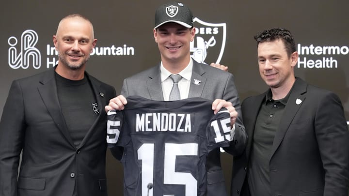 Apr 24, 2026; Henderson, NV, USA; Las Vegas Raiders quarterback Fernando Mendoza (center) poses with general manager John Spytek (left) and head coach Klint Kubiak