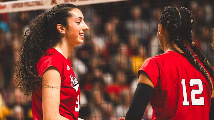 Virginia Adriano slaps hands with Taylor Landfair after a Nebraska point against Minnesota. The freshman opposite recoded eight kills and two blocks against the Gophers. 