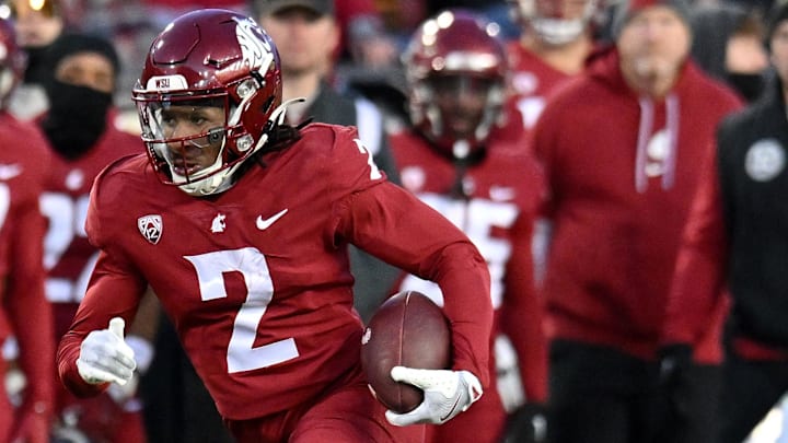 Nov 30, 2024; Pullman, Washington, USA; Washington State Cougars wide receiver Kyle Williams (2) carries the ball against the Wyoming Cowboys in the first half at Gesa Field at Martin Stadium. Mandatory Credit: James Snook-Imagn Images