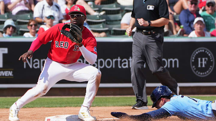 Feb 26, 2026; Fort Myers, Florida, USA; Tampa Bay Rays’ Raynel Delgado (73) steals third base against Boston Red Sox infielder Andruw Monasterio (32) during the fifth inning at JetBlue Park at Fenway South. Mandatory Credit: Jim Rassol-Imagn Images